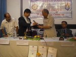 President Rtn. Mangal Man Bajracharya presenting token of love to IPDG Ratna Man Sakya