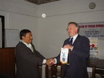 President Rtn. Sargat Vaidya receiving flag of RC Wrexham Yala UK from visiting Rotarian Rtn. Edgar Leiws 