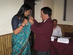 Rotary pin to newly inducted member Ms. Minu Shrestha by DG. Tirtha Man Sakya. on 29th Aug 2010