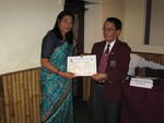 Certificate of Rotary member to newly inducted member Ms. Minu Shrestha by DG Tirtha Man Sakya