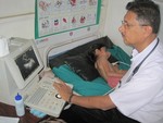 Dr. Prakash Raj Regmi engage in Echo of a child who was suspected in Rheumatic Heart check up on 22nd Aug 013 at Godamchour.