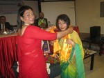 Newly installed President Rtn. Minu Shrestha honoring out going First lady Sabnam Kc.