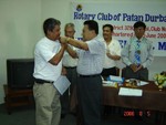 Lapel pin to new Rtn. Om Man Shrestha by AG Rtn. M.L.Kayastha on 5th Aug 06